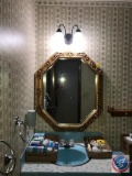 Contents of main floor bathroom to include; wall mirror, wood wall shelf, curling iron, hair dryer,
