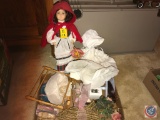 A doll, cloth doll and a flat containing doll stands, wire vase and more