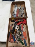 Assorted hand tools including screwdrivers, adjustable wrenches, hog ring pliers, pickle fork and