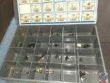 Organizer with assorted air line fittings and hip roof tool box.