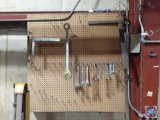 Peg board tool board with wrenches and squares.