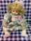 Large porcelain doll with plaid dress blonde hair