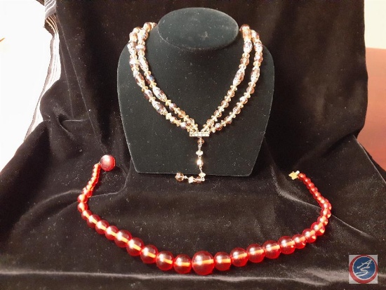 red necklace and a iridescent glass bead necklace