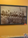 Picture of steel workers having lunch on a beam above the city