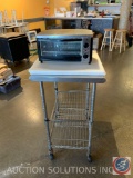 Small toaster oven two cutting boards 15 x 20 on a stainless cart on casters