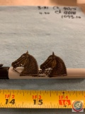 Pair of horse head cufflinks and a horse head pin and a horse head shoe decoration