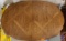 assorted items : oval kitchen table brown tones made of type wood , with 2 attachable leaves...