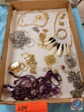 Assortment of gold and silver chains and beaded necklaces...