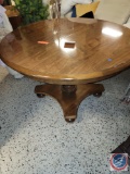 Round wooden table with base stand... and 2 extra leafs to add on...... approx 44 w x 28 1/2 tall...