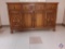 Oak sideboard w/ hand carved drawer & cupboard.... 8 brass pineapple pulls.... 60? W, 20?D, 36? H...