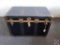 Large black flattop steamer trunk w/ metal fittings & gold rivet accents. Blue interior w/ 2 trays,