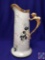 Vintage hand-painted, porcelain pitcher with pink flowers and grapes. Gryphon handle w/gold trim. H