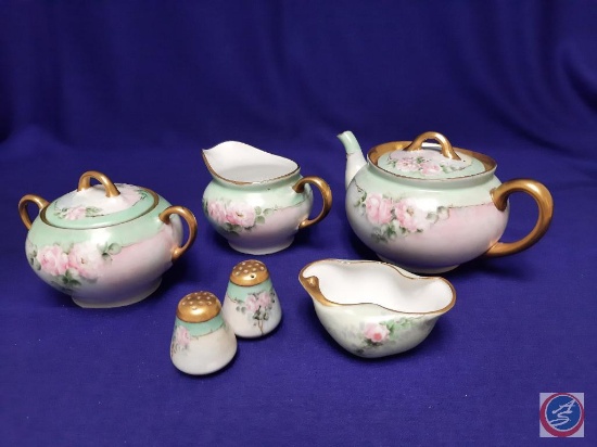 Porcelain matching pieces ? 6 pieces. Teapot, sugar bowl, creamer, salt & pepper shakers. Some wear.