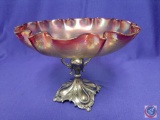 Compote bowl w/ Homan metal stand. Iridescent pink glass w/ scalloped edge. H 7? Dia 11?. Mark on