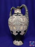 Antique ceramic urn H 18?. Gray w/raised decorative floral design w/stones. Small chip on base