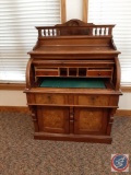 Victorian roll top desk w/ burl walnut. Top panel with 6 spindles and shell design, D cylinder roll