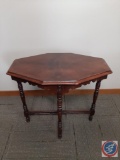 Octagonal end table w/ carved detail on legs. H 29.5?, W 32? D 20?. Note: ?Property of the Sisters