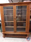 Antique distinctive oak bookcase w/ 2 glass doors & 5 shelves. 28 spindles around the base. 28