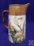 Hand-painted porcelain coffee pitcher. Daffodil design, gold trim. H 8? (Mark: A.M.N. 89)