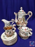 Antique Capodimonte Baroque tea set w/ cherub & dragon designs. Includes 6 saucers and 1 demitasse