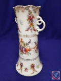 Delicate flowered vase w/ scroll handles. H 10?. Mark: (ES ISH Prussia.) Chip on rim and handle.