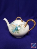 Limoges porcelain teapot w/ lid. Pale blue flowers w/ gold trim. H 4?. Mark: (Limoges, FR. #142) ...