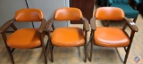 (3) Wood and Orange Vinyl covered chairs.