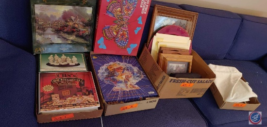 Assortment of items which include, electric heating pad, framed pictures, and puzzles and etc......