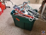 Tote full of plastic clothes hangers.