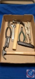 (1)... Flat with (2) Hammers, Vise Grip, Utility Knife, Wire cutters, Folding Hex Key, adjustable