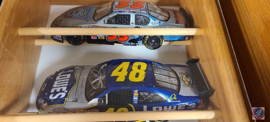 Shadow Box with 5 nascar diecast cars with some certificates of authenticity and some original boxes