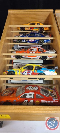 Shadowbox with 5 nascar diecast cars with certificate of authenticity some boxes included