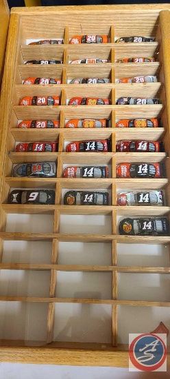 approximately 25 small nascar in a shadow Box