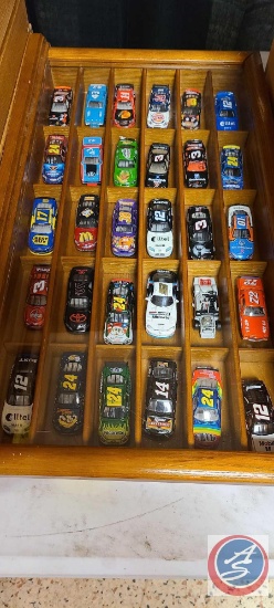 approximately 30 small nascars in a shadow Box