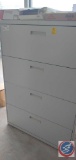 Metal 4 drawer file cabinet with office supplies included.