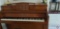 Kranich & Bach Piano with bench, table lamp on top of piano