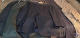 Three men's suit jackets with pants one black pinstripe one blue pin stripe, and a dark and blue