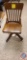 Wooden rolling chair, the chair does still roll and spin. There are some scratches on the chair as