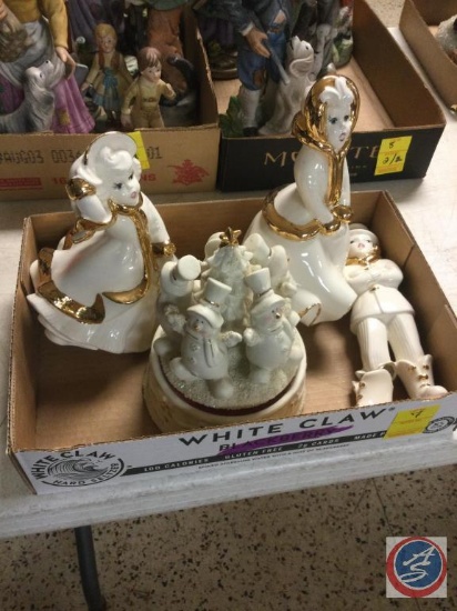 White and golden colored figurines unknown brand. Including music box with snowmen. The male