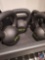 Set of four kettle bells. Weights include 10 lbs, 15 lbs, 20 lbs, and 25 lbs. The shelf is not