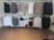 Three wall mounted clothing racking. There are several sections of shelves as well as posts for