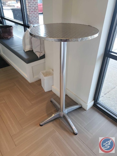 Bar height table by the Belnick LLC. The table is made of metal and a wood composite....
