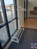 Small metal clothing rack, with lower shelves for shoes. The hangars do have a velvet like material