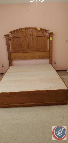 A wood Queen size bed headboard and platform with 3 drawers on each side.