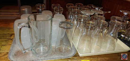 Bar glasses, frosted mugs, shot glasses, mats, trays, and a stainless steel bowl with assorted