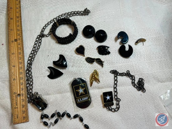 Military tags and black earrings and necklace