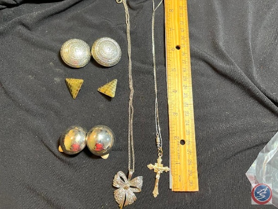 Vintage earrings and a cross on a necklace