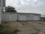Small building with a door and two garage bays. Items inside the building are not included with the