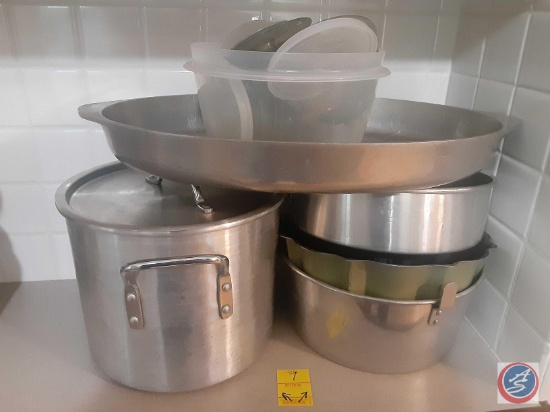 (3) cake pans one stock pot with lid plastic bowl with Tupperware lids.