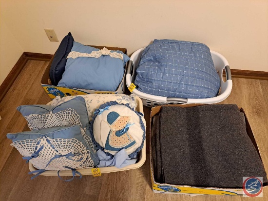Assortment of blankets, pillows, and comforters. Some of the blankets appear to be wool. Several of